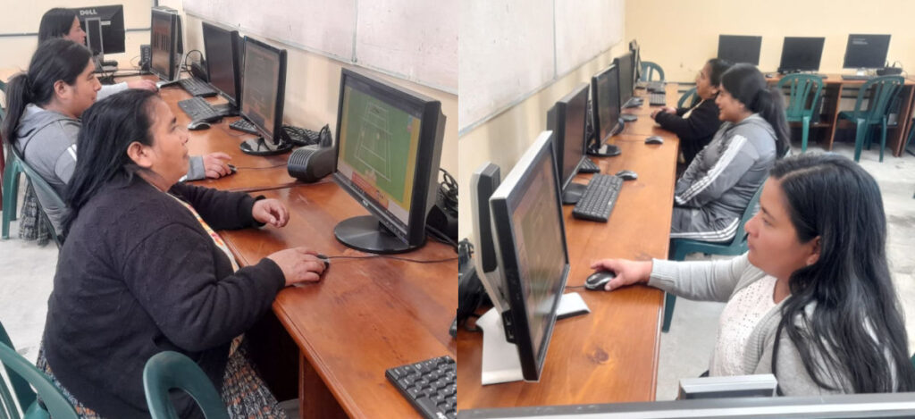 A basic computer lab with Guatemalan women looking at the screen and using the mouse